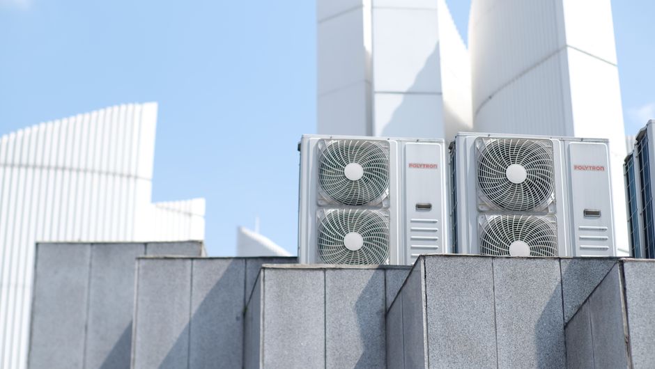 Air conditioner units on a city rooftop in Bandung, Indonesia, showcasing modern urban architecture.