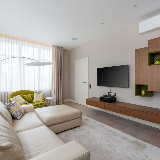 Interior of living room with stylish furniture and large comfortable sofa in luxury apartment in daylight